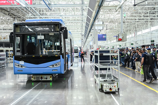 BAIC Foton Bus Global Center Plant interior showing intelligent manufacturing, assembly lines, and advanced bus production.